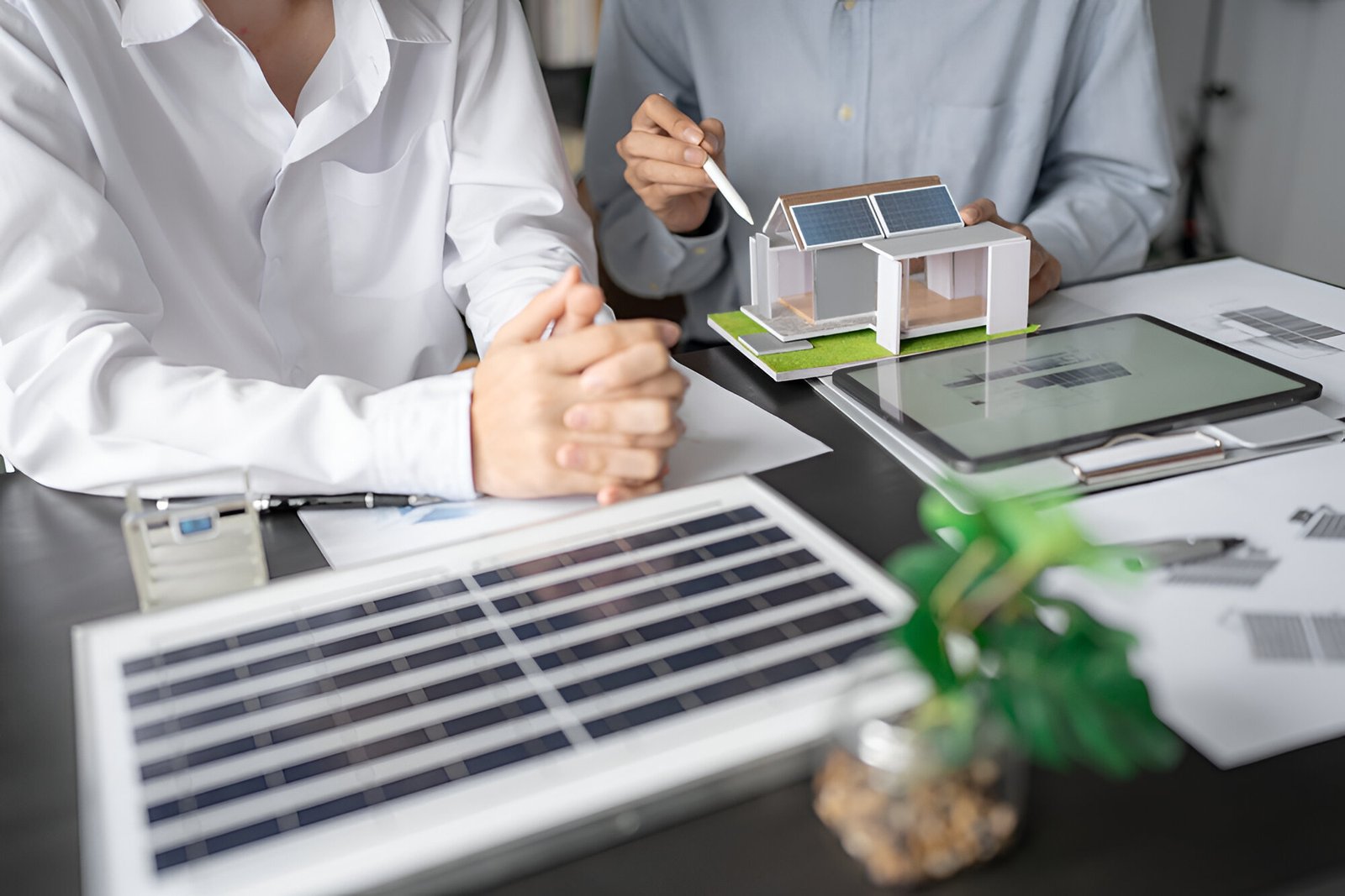 Professionals reviewing a residential roofing model