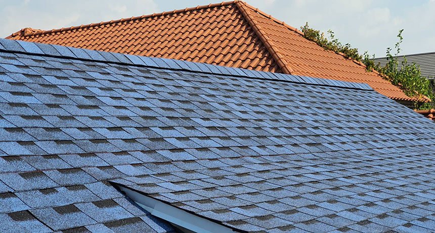 Asphalt shingle residential roof with overlapping gray shingles
